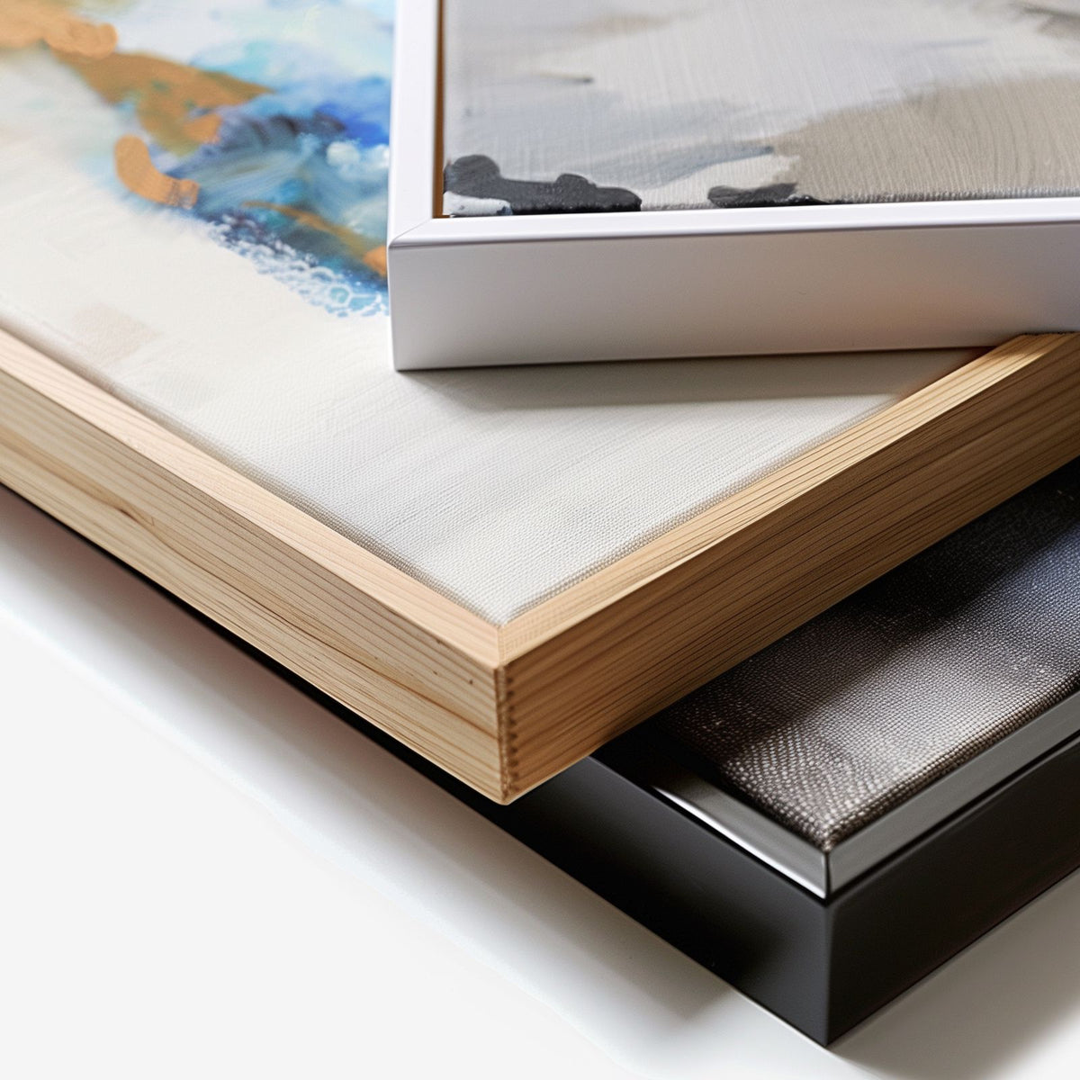 Corner detail of floating frame canvases in white, oak and black